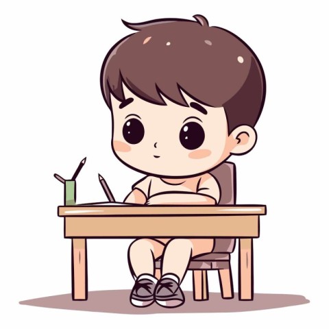 Little boy sitting at the table and writing in notebook.