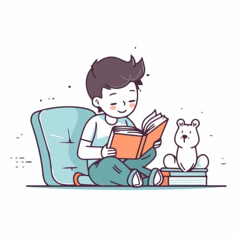 Cute little boy reading a book while sitting on the sofa.