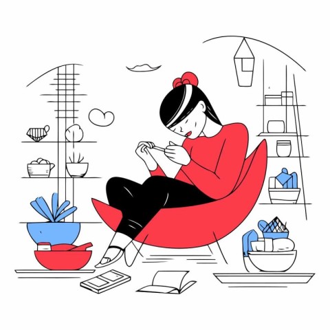 Young woman sitting in a chair and reading a book