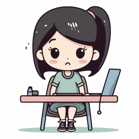 Cute little girl sitting at the table and using laptop.