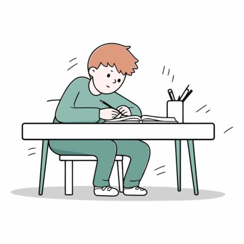 Boy sitting at the table and writing in notebook.