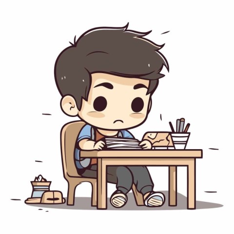 Sad boy sitting at the table and reading a book.