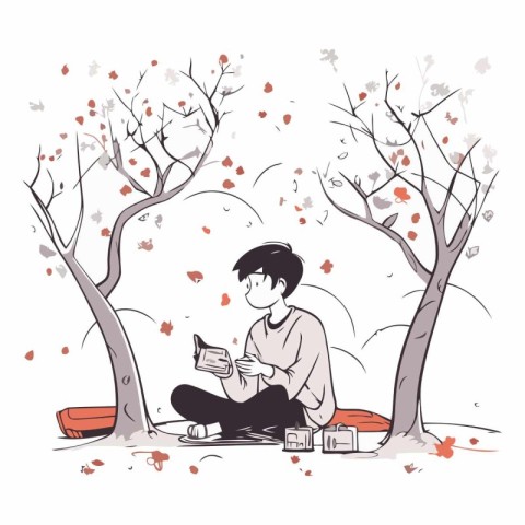 Young man reading a book in the autumn park.