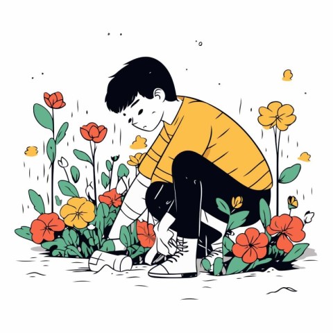 Young man sitting on the ground surrounded by flowers.