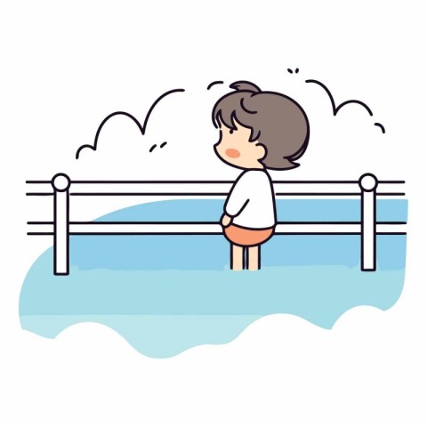 Little boy sitting on a wooden fence in the water