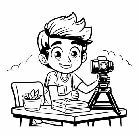 Boy with a camera and a book on the table.