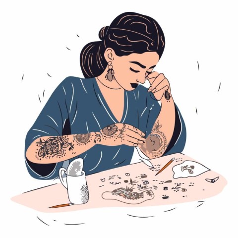 Tattooed woman sitting at the table and eating cake.