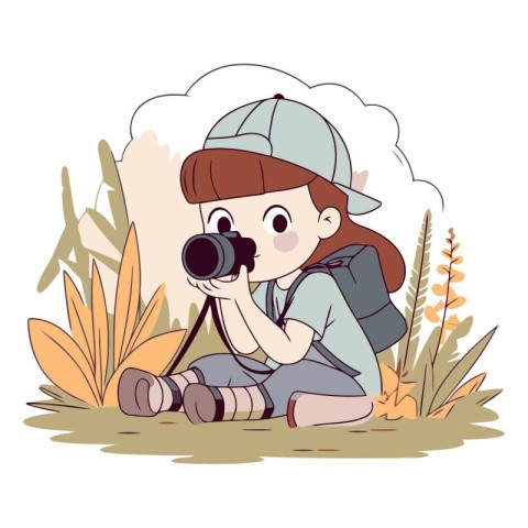 Cute little girl with camera sitting in the grass.