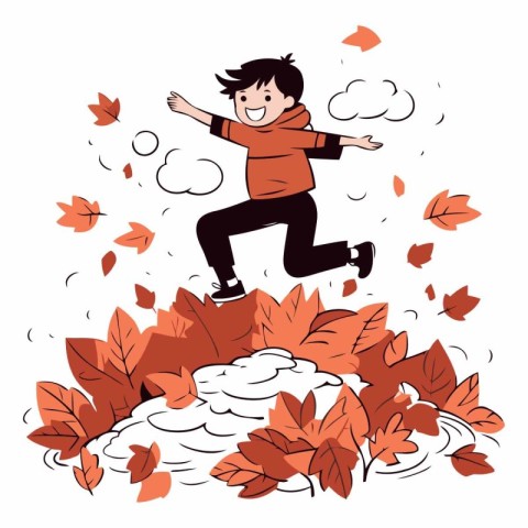 Happy boy jumping on a pile of autumn leaves.