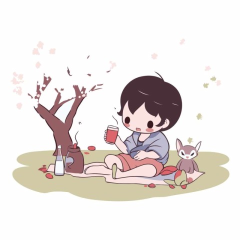 A cute little boy sitting on the grass with a cat and drinking c