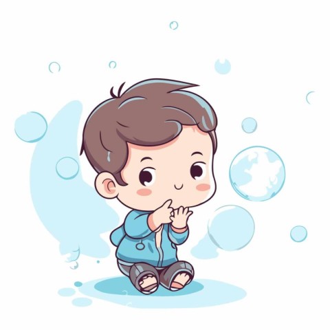 Cute little boy sitting on the ground and blowing soap bubbles.