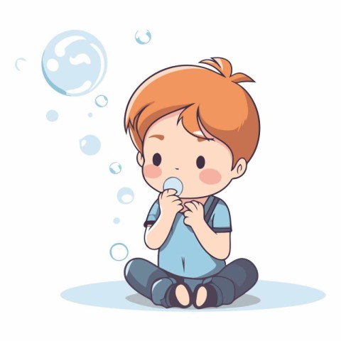 Cute little boy sitting and blowing soap bubbles.