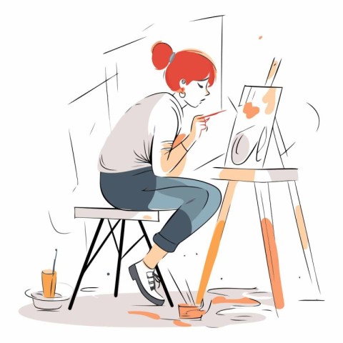 Young woman paints a picture in the artist's studio