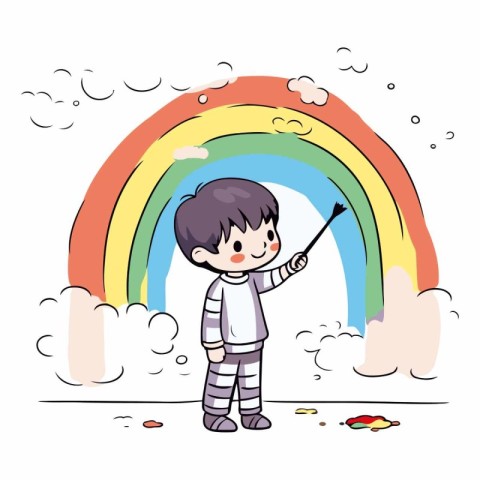 Cute little boy painting with a brush on the rainbow.