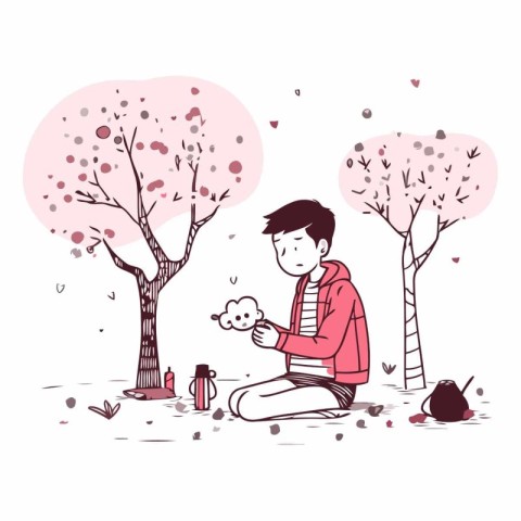 Young man sitting in the park and playing with his dog.