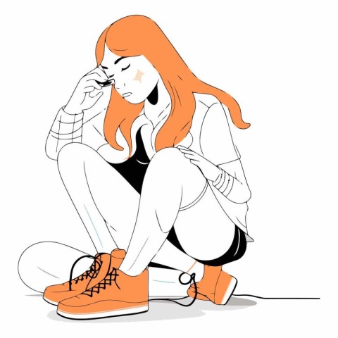 Sad young woman sitting on the floor and crying.