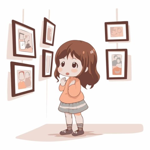 Cute little girl looking at pictures in art gallery