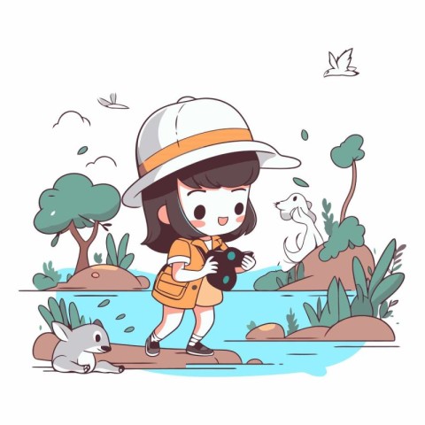 Little girl in safari outfit and hat standing on river bank with