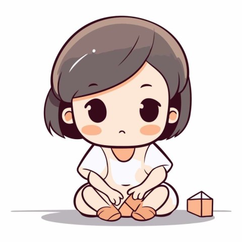 Little girl sitting and playing with a wooden cube.