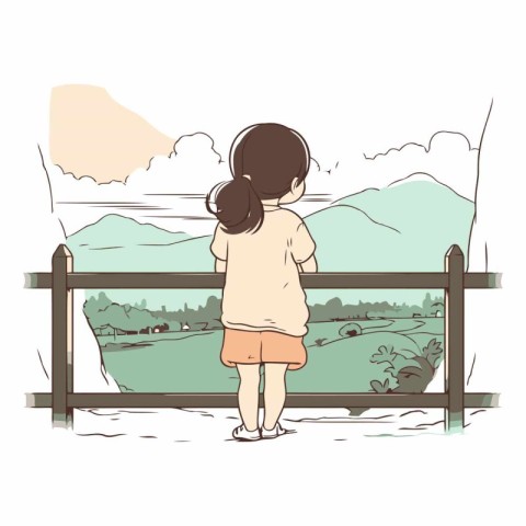 Little girl standing at the fence and looking at the mountains.